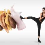 Fit young woman fighting off fast food